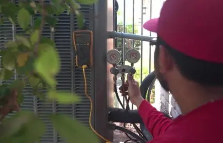 A#1 Air Technician Performing AC Repair in Lewisville, TX A#1 Air technician repairing an outdoor AC unit in Lewisville, TX for dependable cooling solutions.