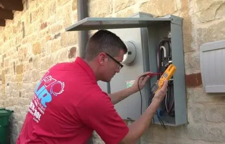A#1 Air Technician Ensuring AC System Reliability in Lewisville, TX A#1 Air technician working on an electrical panel to support AC repair in Lewisville, TX.
