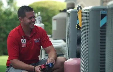 A#1 Air Technician Performing AC Diagnostics in Lewisville, TX A#1 Air technician checking electrical currents on an outdoor AC unit with a voltmeter in Lewisville, TX.